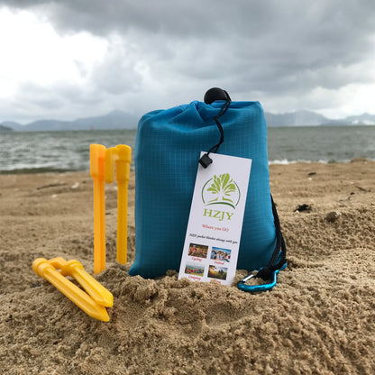 HZJOYUE Outdoor Picnic Blanket (71" x 55") -Compact, Lightweight, Sand Proof Pocket Blanket for The Beach, Hiking, Travel, Camping, Festivals with Pockets, Loops, Stakes, Carabiner (Blue)