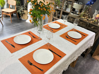 ANDSTAR Non-Slip Waterproof Placemats Set of 6 - Reusable Wipeable Table Mats for Dining Table, Kitchen, Outdoor Picnic, 12x18 Inch PVC Backed Heat Resistant Place Mats Dishwasher Safe（Orange）