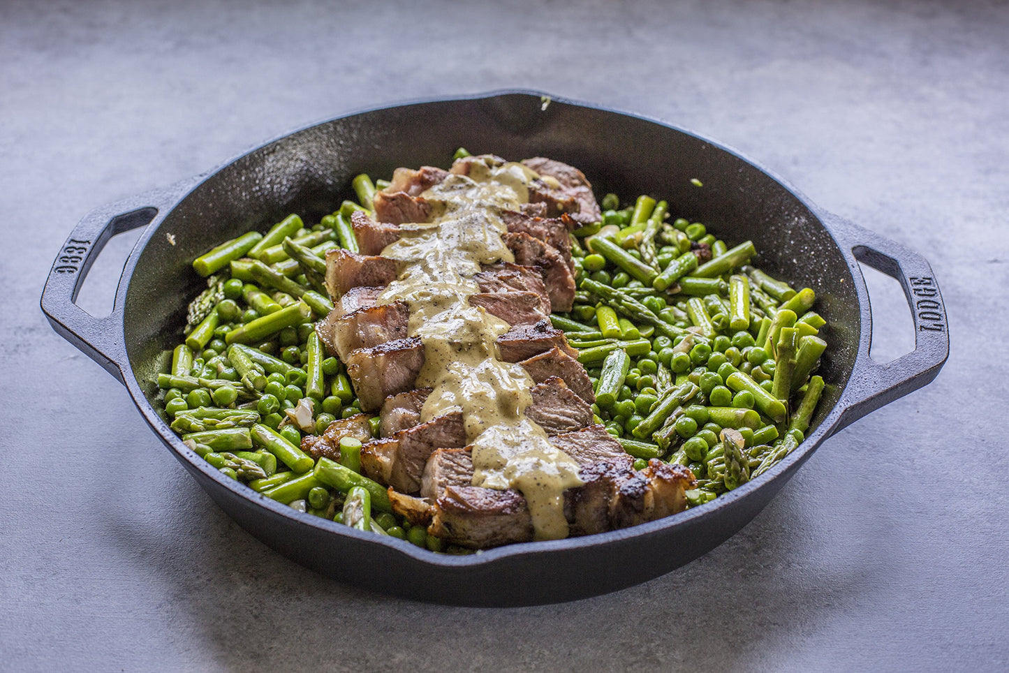 Lodge 12 Inch Pre-Seasoned Cast Iron Skillet - Dual Assist Handles - Use in the Oven, on the Stove, on the Grill, or Over a Campfire - Black